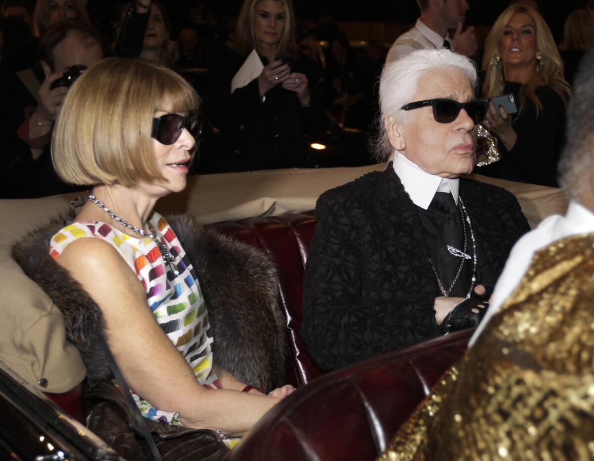 Anna Wintour, left, editor in chief of Vogue, rides with designer Karl Lagerfeld to a December event in Dallas.