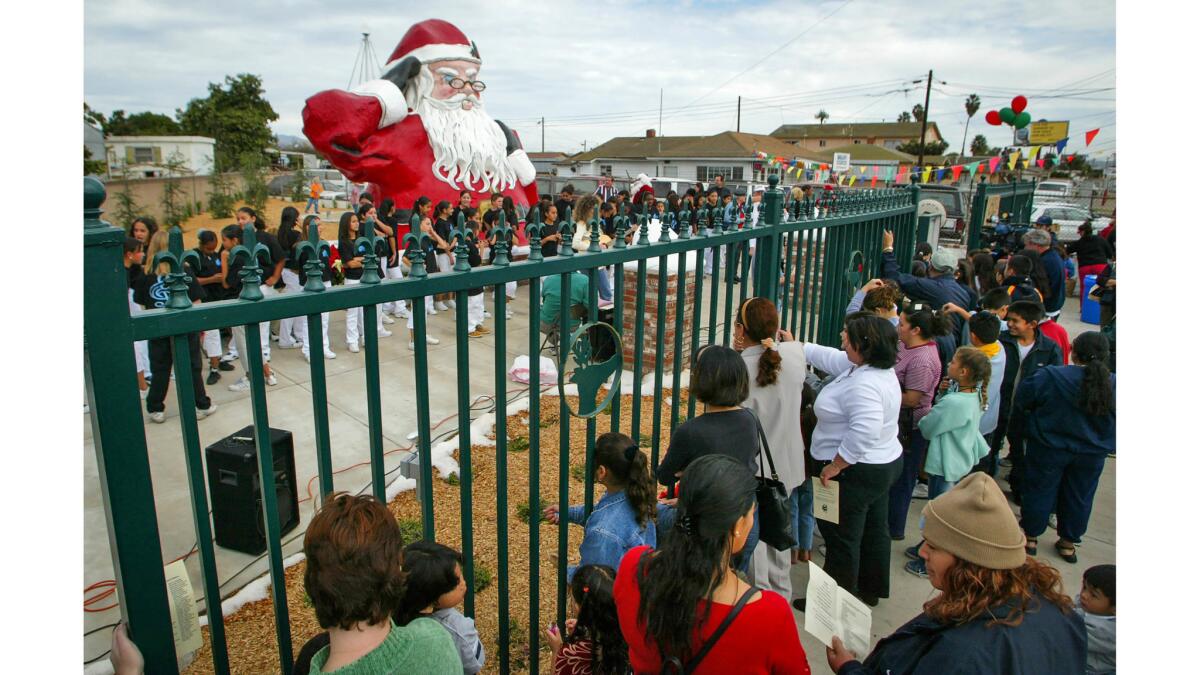 Nov. 28, 2003: Well-wishers gather at the dedication ceremony for the 5-ton statue at the new Santa Park in Nyeland Acres.