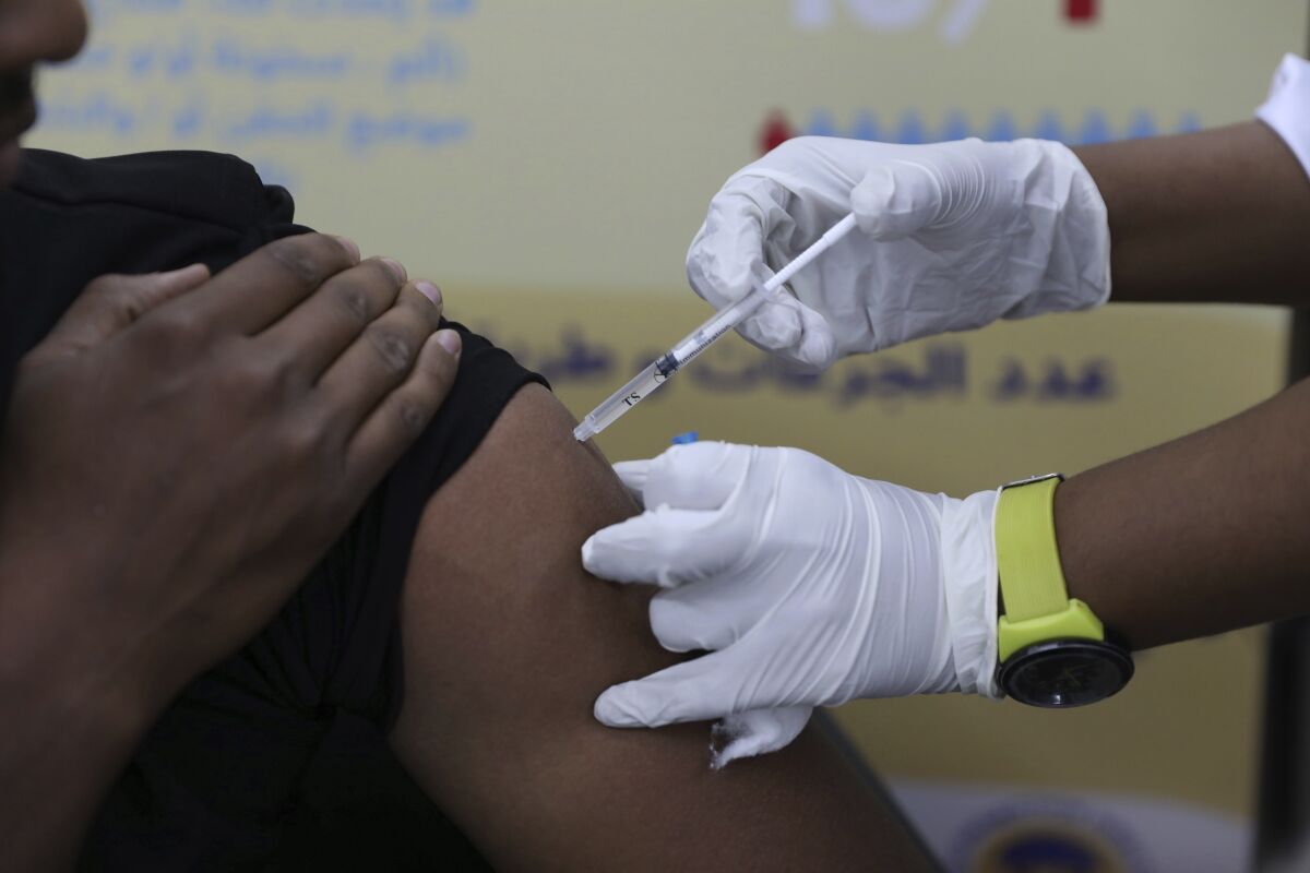 FILE - A man receives the AstraZeneca COVID-19 vaccine at Jabra Hospital in Khartoum, Sudan, Thursday, March 11, 2021. A new philanthropic project hopes to invest $100 million in up to 10 countries mostly in Africa by 2030 to support up to 200,000 community health workers. (AP Photo/Marwan Ali, File)