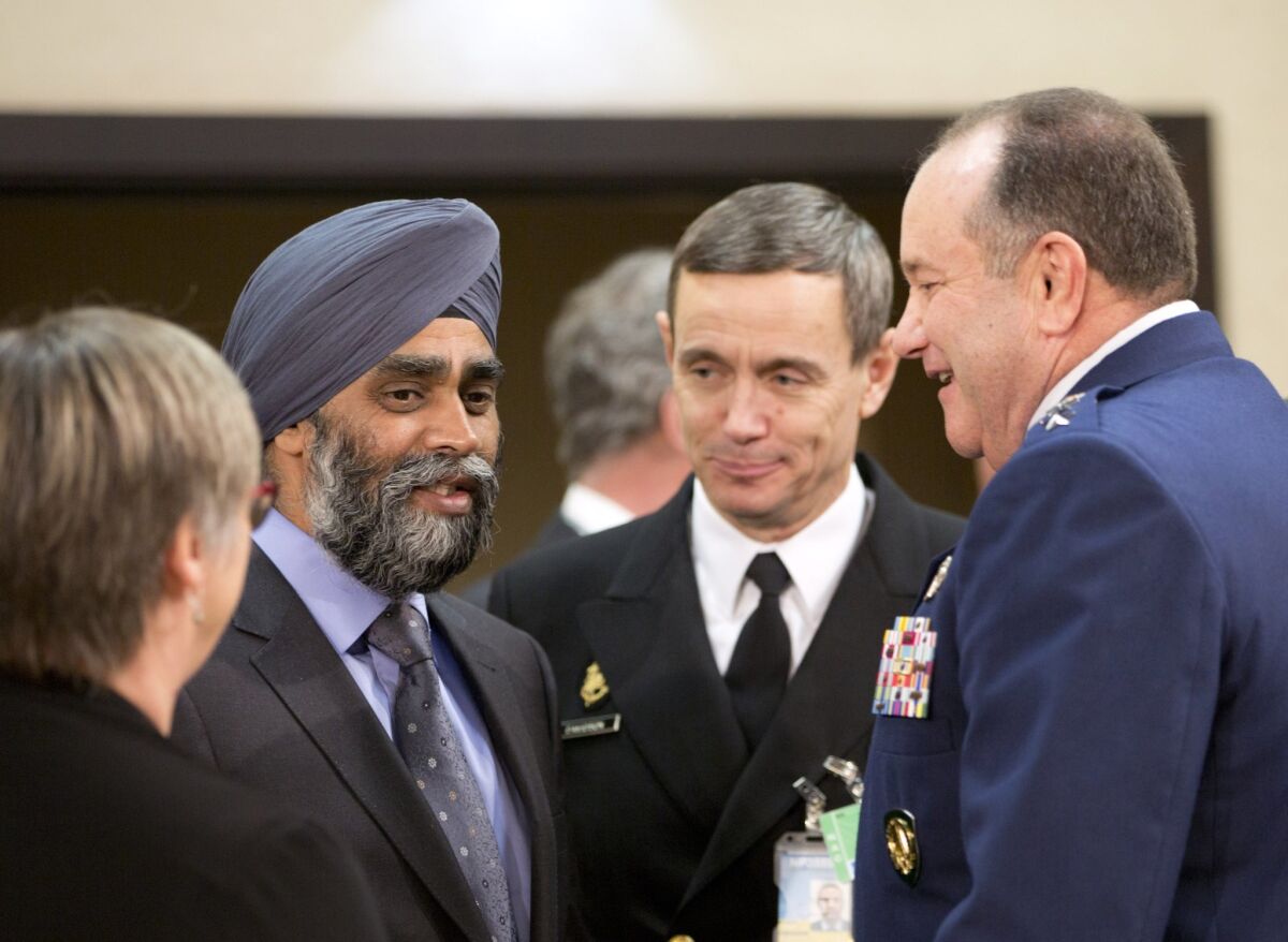 Canadian Defense Minister Harjit Singh Sajjan speaks with U.S. Gen. Philip Breedlove, supreme allied commander in Europe, right, during a meeting of the North Atlantic Council at NATO headquarters in Brussels.