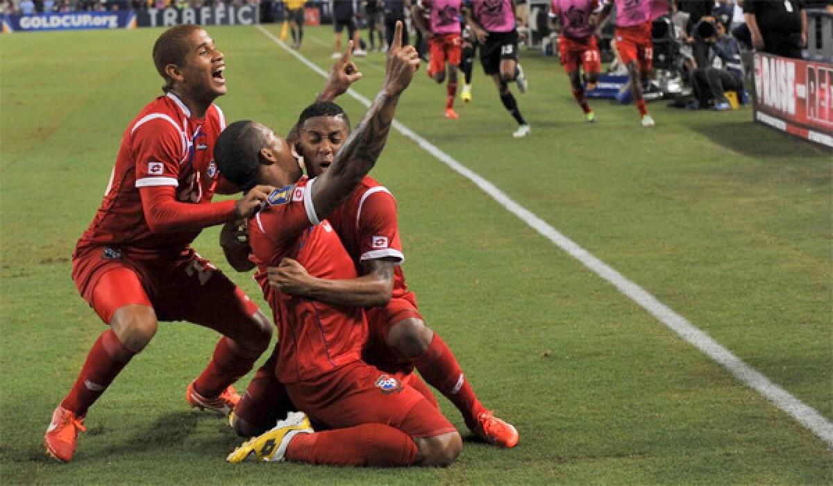 Roman Torres, center, Roberto Chen, left and Gabriel Torres celebrate after scoring against Mexico during Panama's 2-1 victory to advance to the Gold Cup final against the United States.