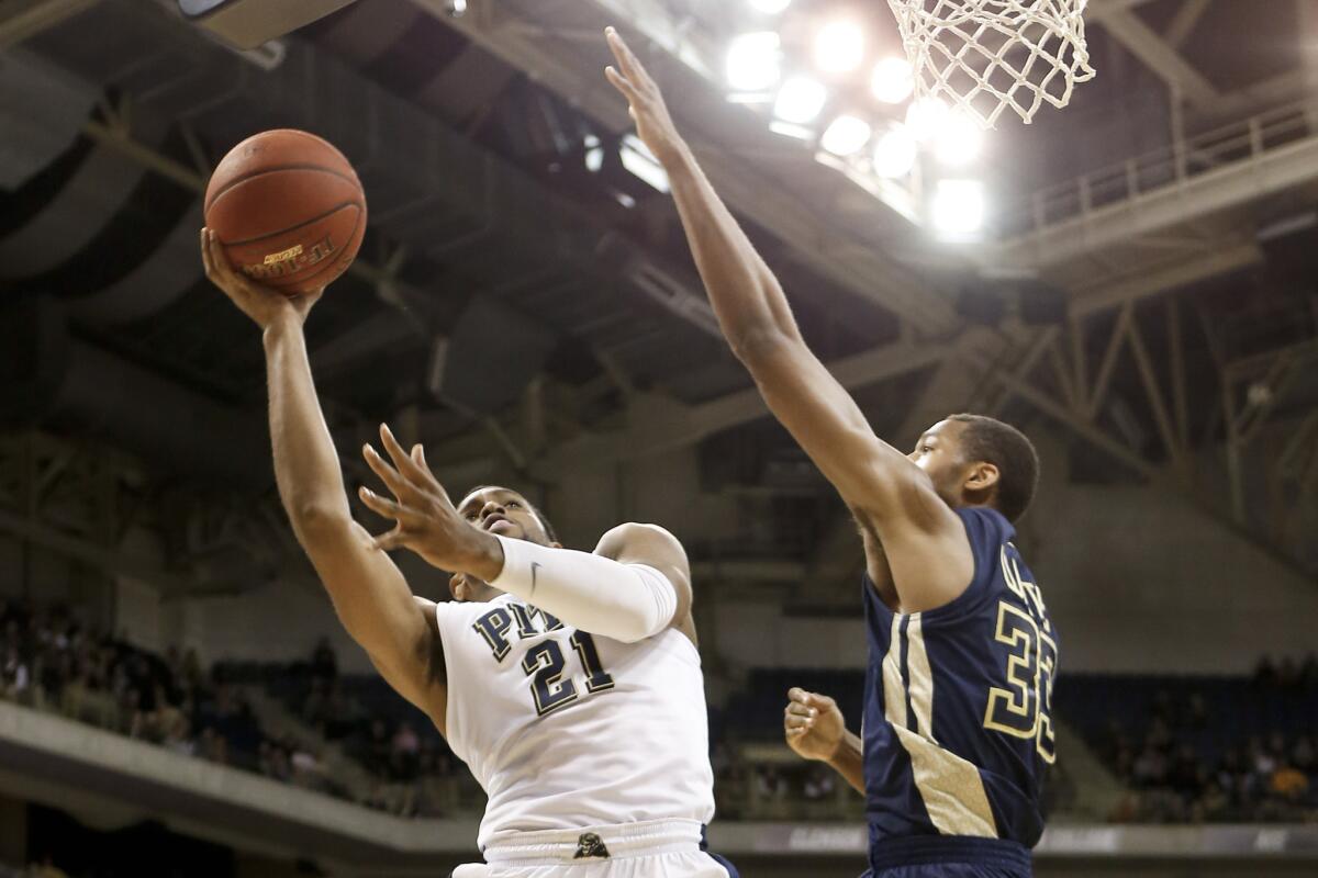 Pittsburgh's Sheldon Jeter (21) shoots around a Georgia Tech defender during the Panthers' 89-84 victory.