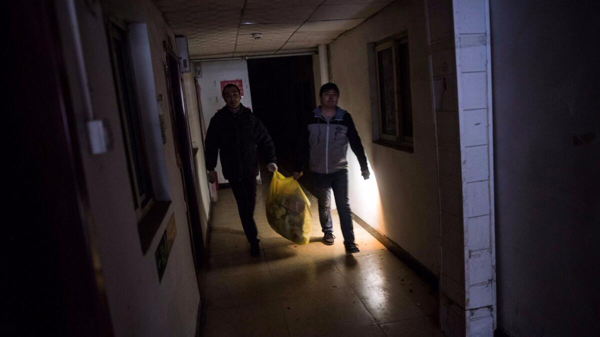 Residents leave their home on the outskirts of Beijing on Nov. 27, 2017, after receiving eviction notices.