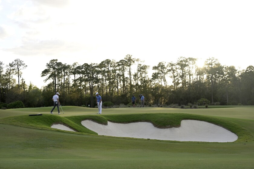 Collin Morikawa, left, and Billy Horschel check the 18th green before putting during the third round of the Workday Championship golf tournament, Feb. 27, 2021, in Bradenton, Fla. (AP Photo/Phelan M. Ebenhack)