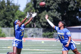 Crenshaw's Alani Anderson (left) and Talita Robinson go all out trying to make interception.