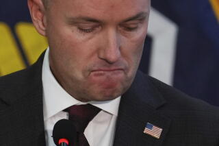 Utah Gov. Spencer Cox pauses as he speaks at a news conference.