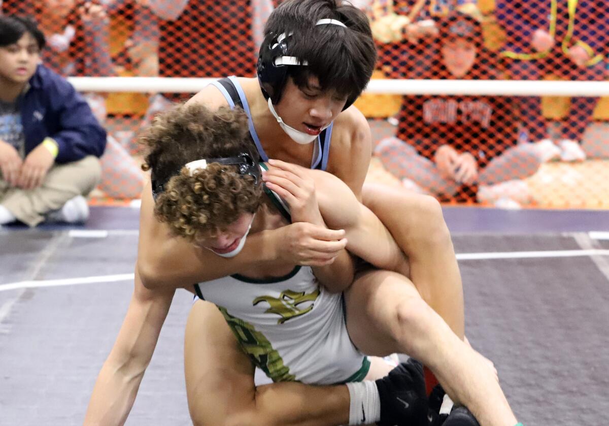 Corona del Mar's Angelo Gonzalez competes against Royal's Mason Carrillo in the 120-pound final of the Mann Classic.