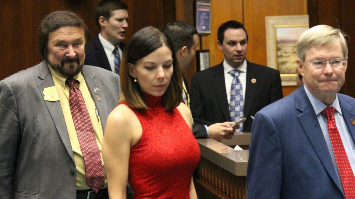 Arizona state Rep. Michelle Ugenti-Rita leaves the House speaker's office along with Reps. Jay Lawrence, left, and Vince Leach, right, on Feb. 1, 2018.