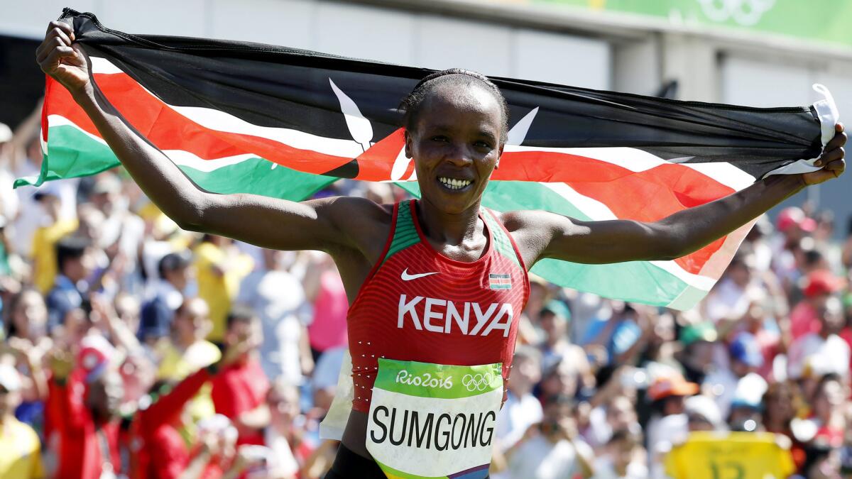 Jemima Sumgong celebrates after winning the women's marathon on Sunday.