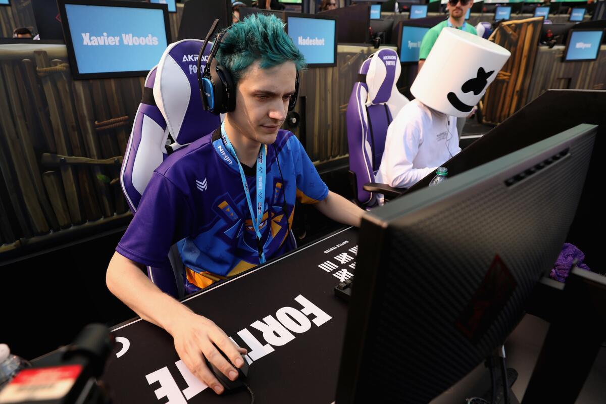 Gamers "Ninja," left, and "Marshmello" compete in the Epic Games Fortnite E3 Tournament in Los Angeles on June 12.