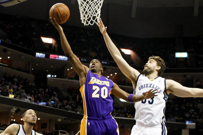 Lakers guard Jodie Meeks gets past center Marc Gasol and the Grizzlies defense for a layup in the first half Wednesday night in Memphis.