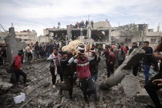 Palestinians evacuate a wounded woman following Israeli airstrikes in Khan Younis refugee camp, southern Gaza Strip, Thursday, Dec. 7, 2023. (AP Photo/Mohammed Dahman)