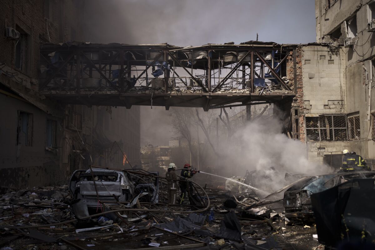 Firefighters work to extinguish multiple fires after a Russian attack in Kharkiv, Ukraine, Saturday, April 16, 2022. (AP Photo/Felipe Dana)
