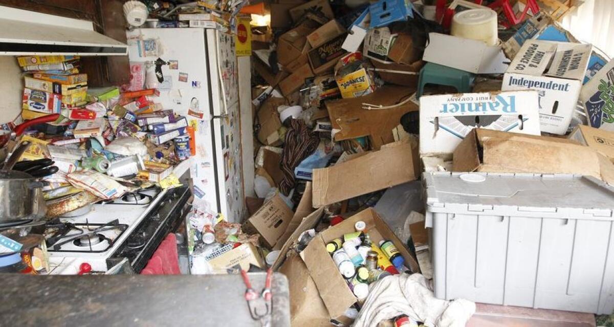 The kitchen of a home in Mira Mesa is piled with assorted boxes and trash.