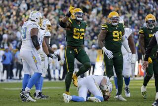 Packers linebacker Rashan Gary (52) reacts after sacking Chargers quarterback Justin Herbert (10).