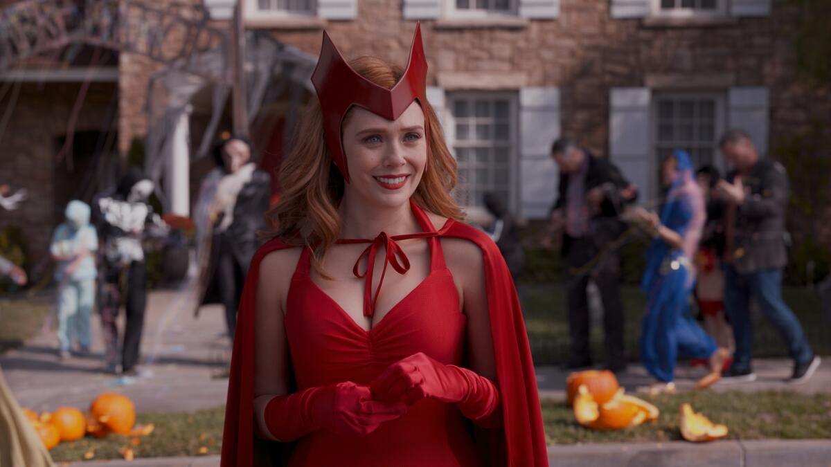 Elizabeth Olsen in costume in a Halloween scene on set.