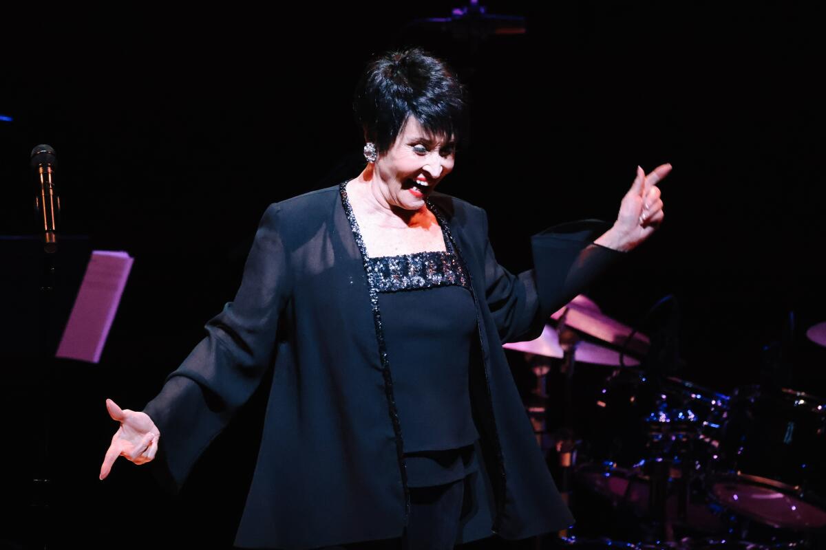 Chita Rivera smiles and points onstage.