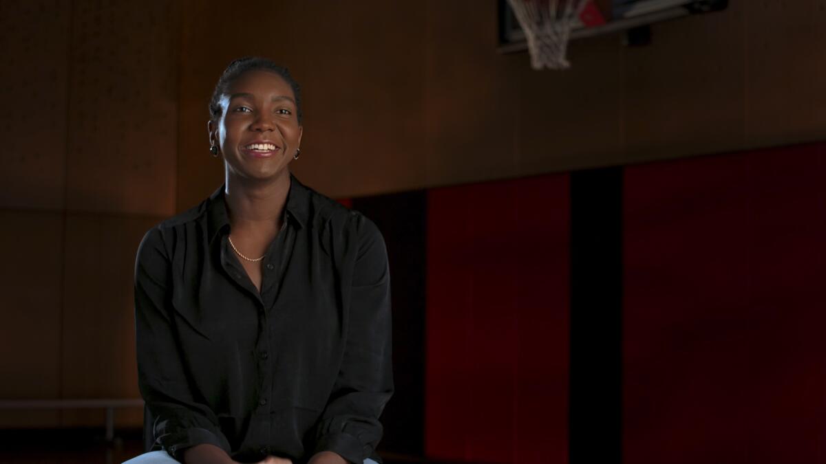 WNBA player Elizabeth Williams speaking in a documentary from a basketball court