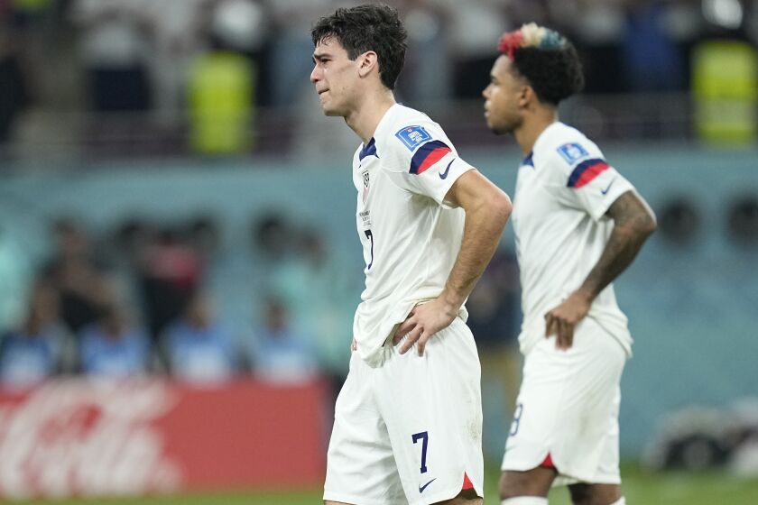 Gio Reyna of the United States, center, is dejected after the World Cup round of 16 soccer match between the Netherlands and the United States, at the Khalifa International Stadium in Doha, Qatar, Saturday, Dec. 3, 2022. Netherlands won 3-1. (AP Photo/Ebrahim Noroozi)