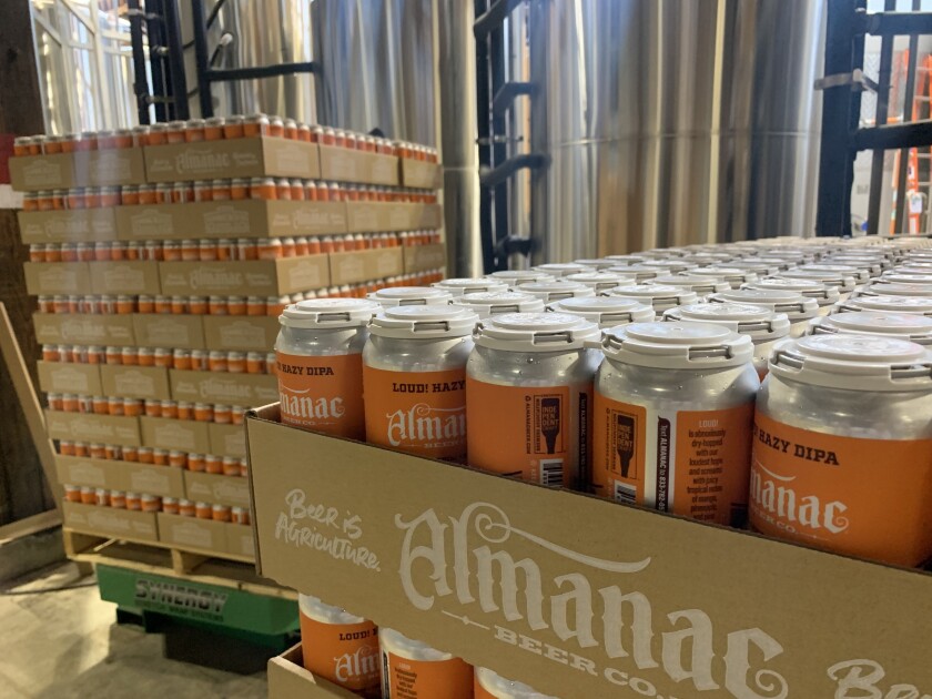 Freshly filled cans of beer sit on pallets at Almanac Beer Co.'s brewery.