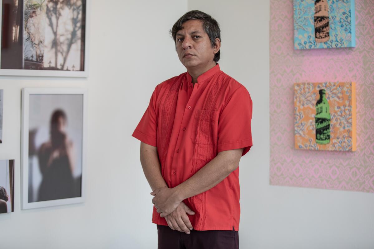 Francisco Morales, director of the Front Arte & Cultura, stands in the gallery at an exhibition in March 2021