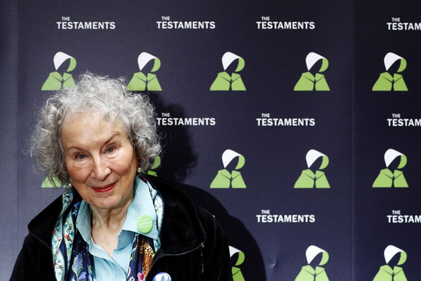 FILE - In this Tuesday, Sept. 10, 2019 file photo, Canadian author Margaret Atwood poses for a photograph during a press conference at the British Library to launch her new book 'The Testaments' in London. Booker Prize winner Margaret Atwood is the bookies' favorite to win the coveted fiction trophy again for "The Testaments," her follow-up to dystopian saga "The Handmaid's Tale." Atwood is one of six finalists for the 50,000-pound ($63,000) prize, whose winner will be announced Monday Oct. 14, 2019. (AP Photo/Alastair Grant, File)