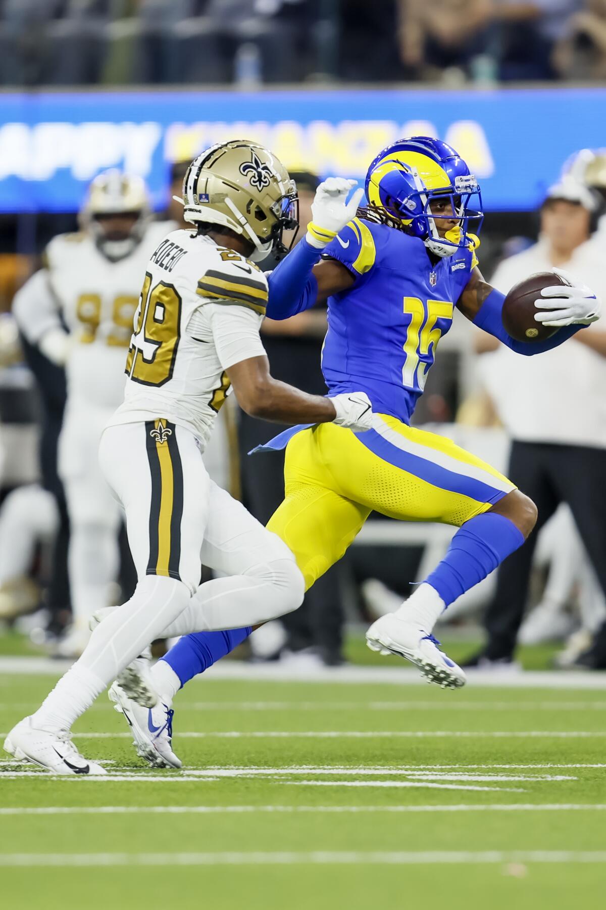 Rams receiver Demarcus Robinson runs for yardage after a catch.