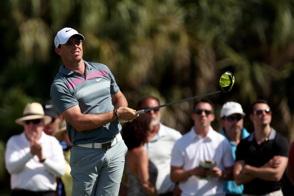 Rory McIlroy of Northern Ireland watches his tee shot from the seventh hole of Trump National during the second round of play Friday at the WGC-Cadillac Championship in Doral, Fla.