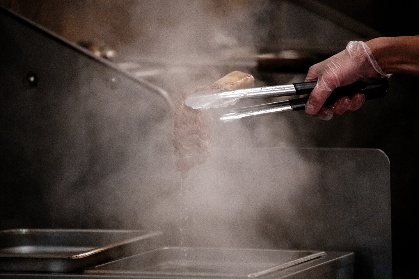 IRVINE, CA - FEBRUARY 09: Inside the kitchen of Sup Noodle Bar where owner, chef Viet Nguyen, demonstrates the process of making his Rib bone pho on Tuesday, Feb. 9, 2021 in Irvine, CA. (Mariah Tauger / Los Angeles Times)