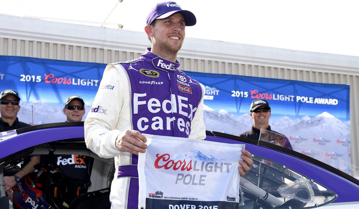 Denny Hamlin poses with the pole award after winning the position for Sunday's NASCAR Sprint Cup series auto race on Friday at Dover International Speedway.