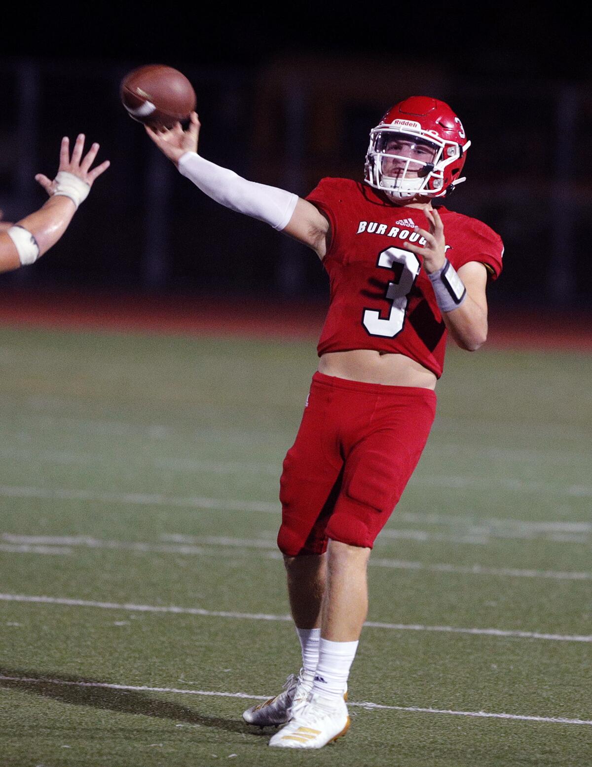 Burroughs' quarterback Nicholas Garcia falls back and passes against Crescenta Valley in a Pacific League football game at Memorial Field in Burbank on Tuesday, September 27, 2019.