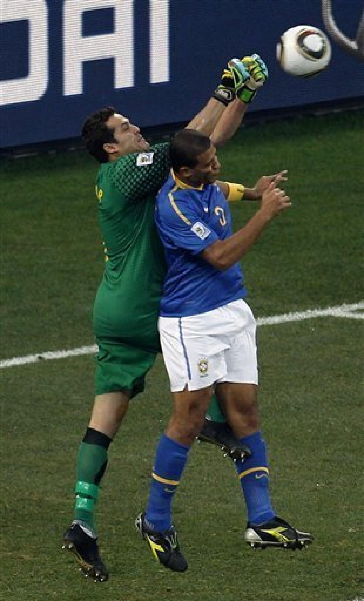 Brazil's Felipe Melo, right, heads the ball past Brazil goalkeeper Julio Cesar, left, before it goes into the net to score an own goal during the World Cup quarterfinal soccer match between the Netherlands and Brazil at Nelson Mandela Bay Stadium in Port Elizabeth, South Africa, Friday, July 2, 2010. (AP Photo/Roberto Candia)