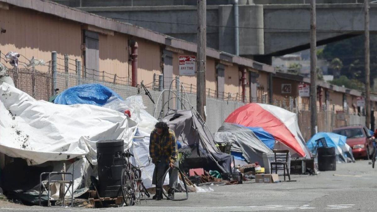 A row of tents occupy a street in San Francisco.