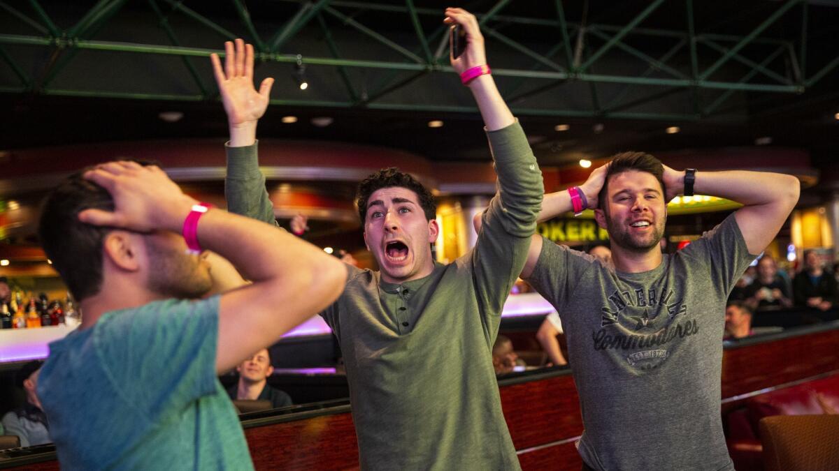 Meat Stevens, from New York, NY, center, and his friends react to a NCAA march madness basketball game being televised at the Superbook at the Westgate Hotel on March 21, 2019 in Las Vegas.