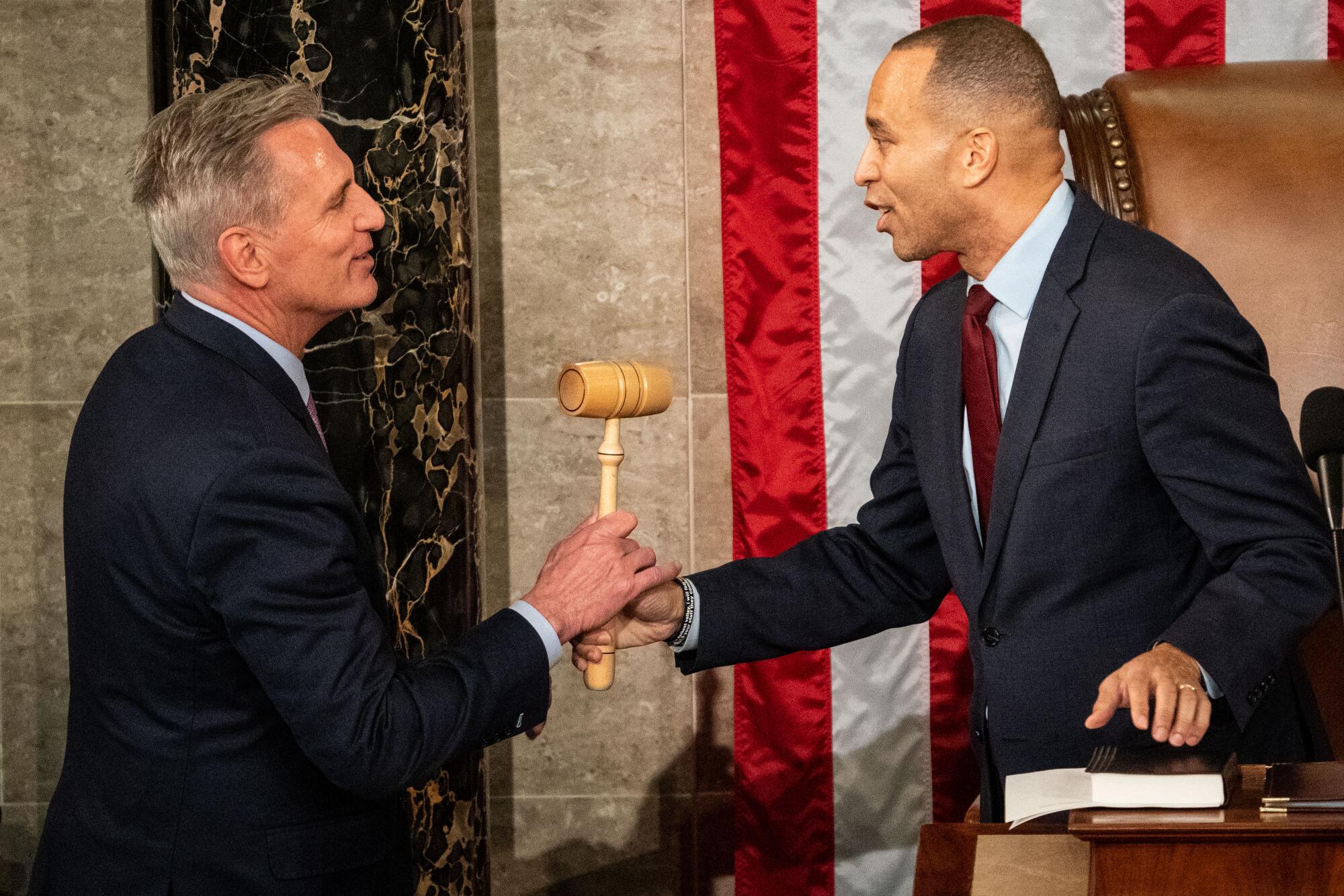 Rep. Kevin McCarthy, left, accepts the gavel from Rep. Hakeem Jeffries. 
