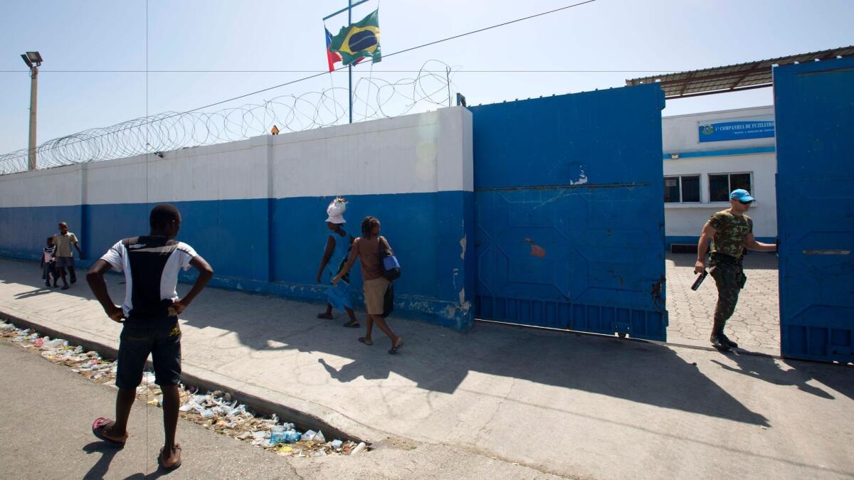 A U.N. peacekeeper opens a gate at the U.N. base in the Cite Soleil slum of Port-au-Prince, Haiti, on Aug. 16, 2016.