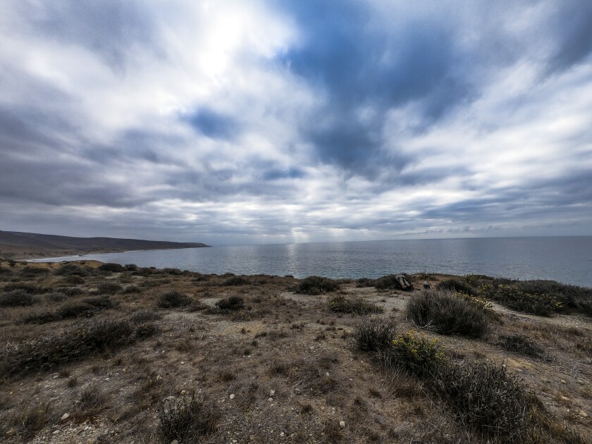 An uninhabited stretch of coastline under the clouds