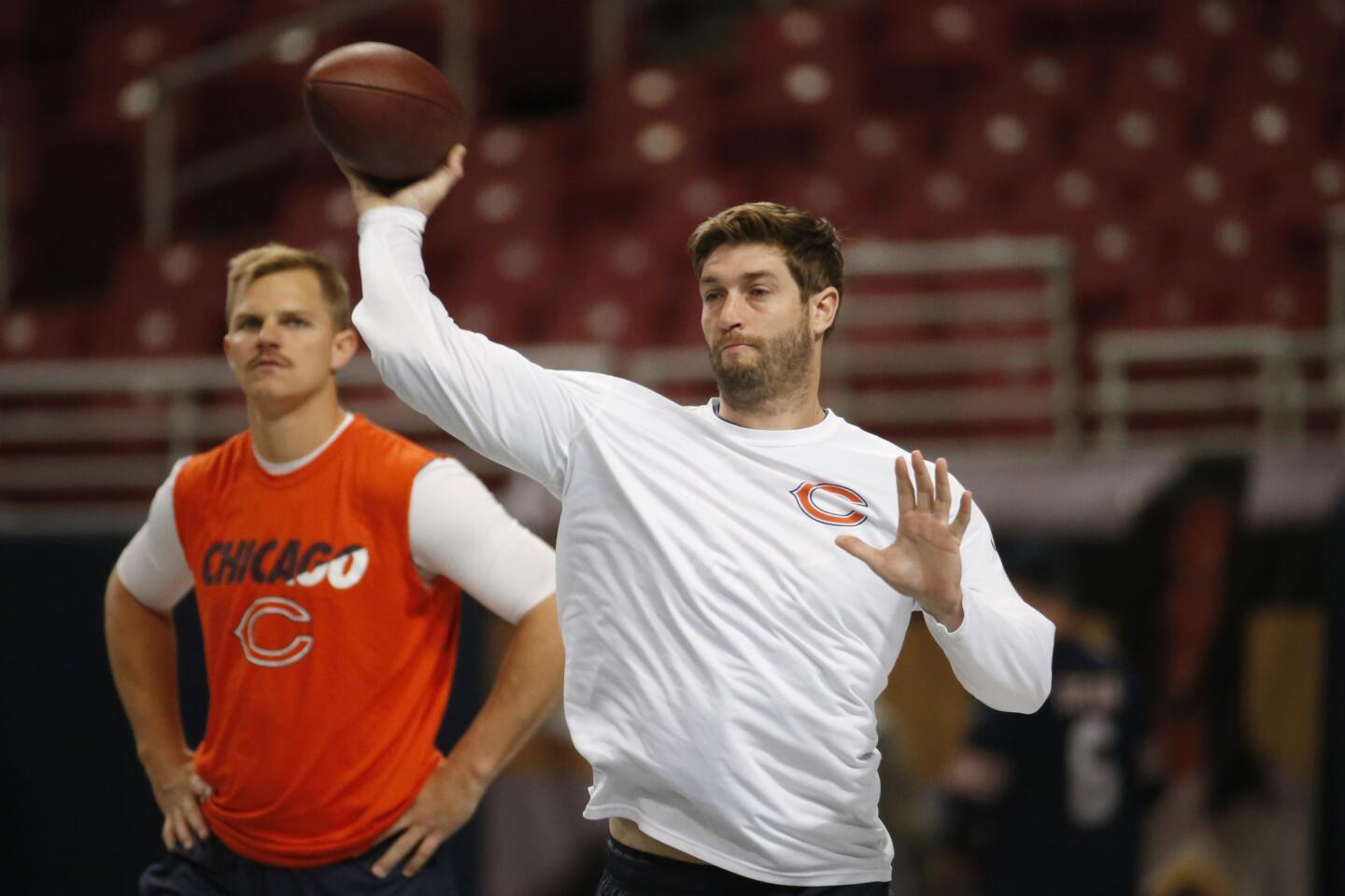 Jay Cutler throws during warm-ups as Jimmy Clausen looks on before the game against the Rams.