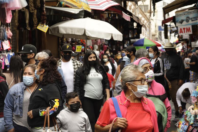 LOS ANGELES, CA - JUNE 7, 2021 - - Shoppers make their way through Santee Alley in downtown Los Angeles on June 7, 2021. California continues to help set the pace for U.S. COVID-19 recovery, now ranked by the Centers for Disease Control and Prevention as one of just two states at the lowest level of coronavirus community transmission. In fact, according to the CDC's four-level color-coded system, California's transmission metrics were the lowest out of all 50 states as of Saturday. The CDC determines the level of community transmission based on the number of cases in the last seven days per population of 100,000, and the number of tests in the last seven days that yield a positive result. JUNE 07: Los Angeles Monday, June 7, 2021 Los Angeles, CA. (Genaro Molina / Los Angeles Times)