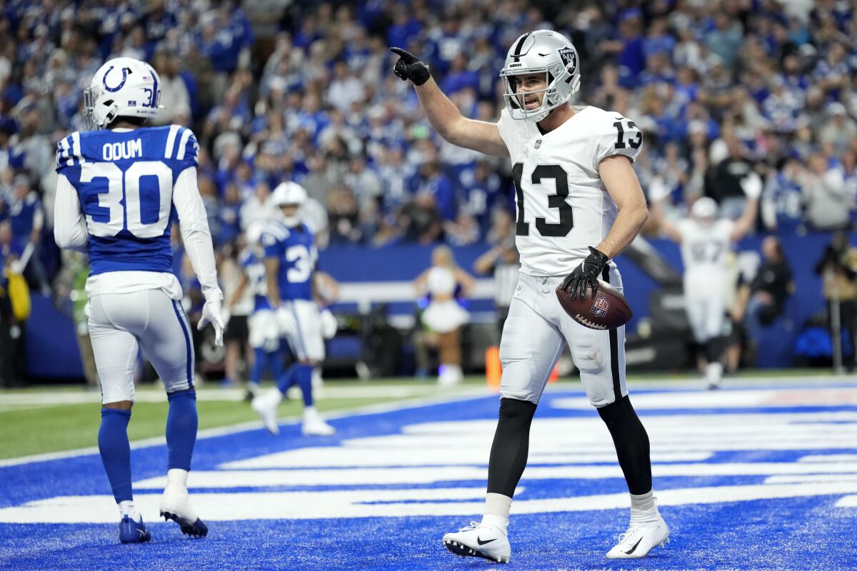 Las Vegas Raiders wide receiver Hunter Renfrow (13) celebrates in front of Indianapolis Colts safety George Odum (30) after catching an 11-yard touchdown pass during the second half of an NFL football game, Sunday, Jan. 2, 2022, in Indianapolis. (AP Photo/AJ Mast)