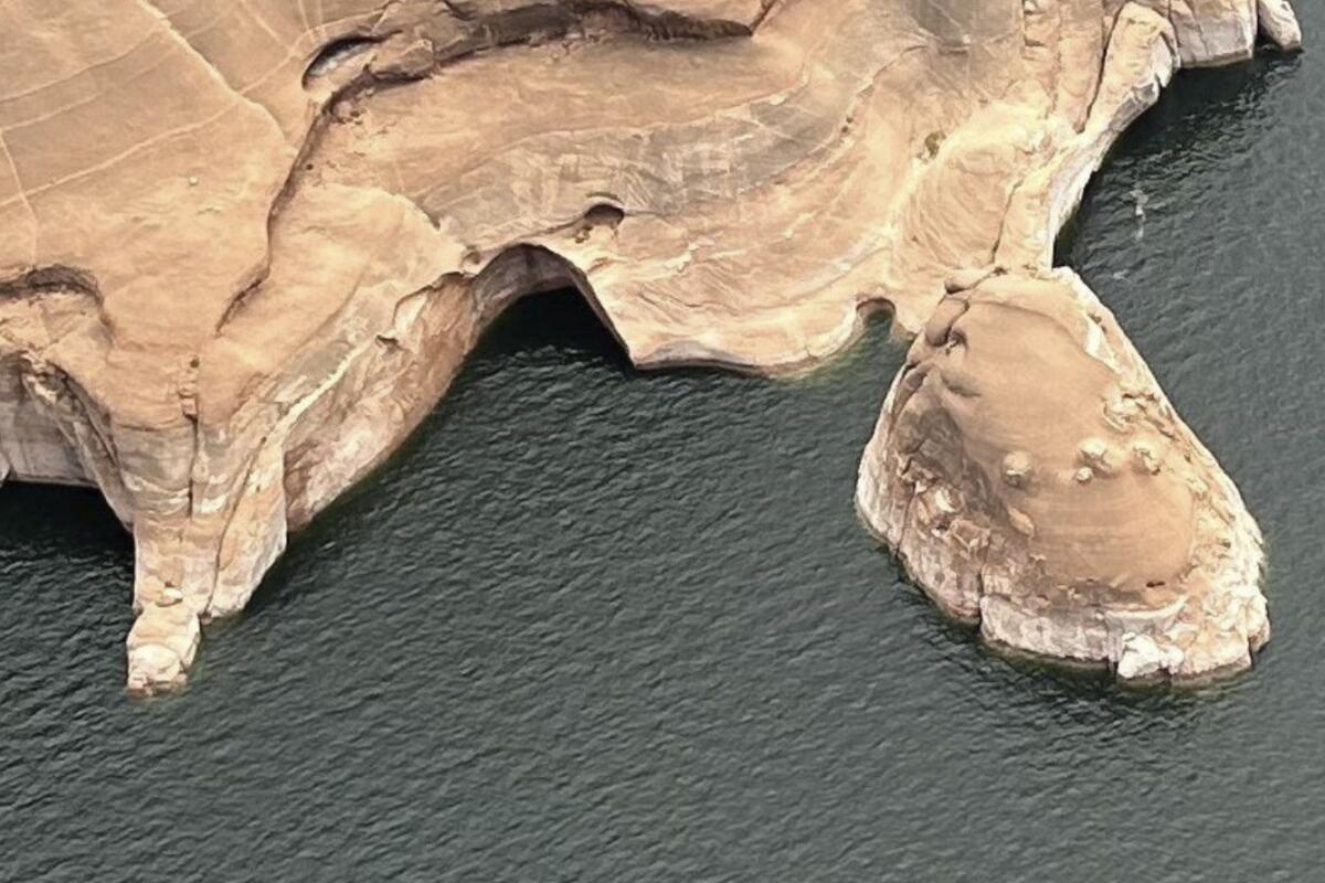 The Double Arch, center, is shown after its collapse, at the Glen Canyon National Recreation Area, Utah. 