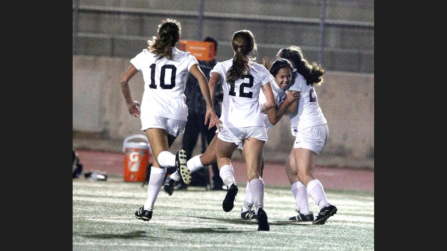 Flintridge Sacred Heart Academy's Amethyst Trang is surrounded by teammates after she scored the game winning goal against Marlborough in the final minute of play in a Mission League girls' soccer game at Occidental College on Wednesday, January 10, 2018. FSHA won the game 2-1 on a goal in the final minute of the game.
