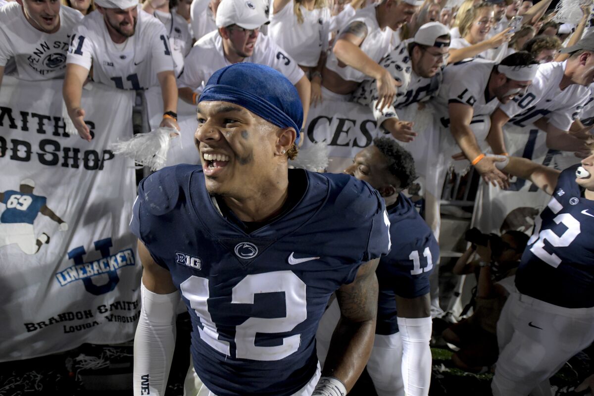 Penn State linebacker Brandon Smith (12) celebrates with fans after a victory over Auburn on Sept. 18, 2021.