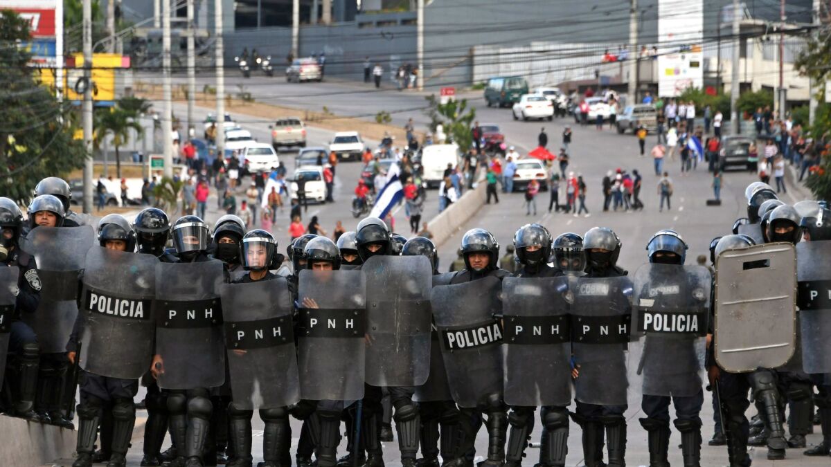 Police block a road in the Honduran capital of Tegucigalpa.