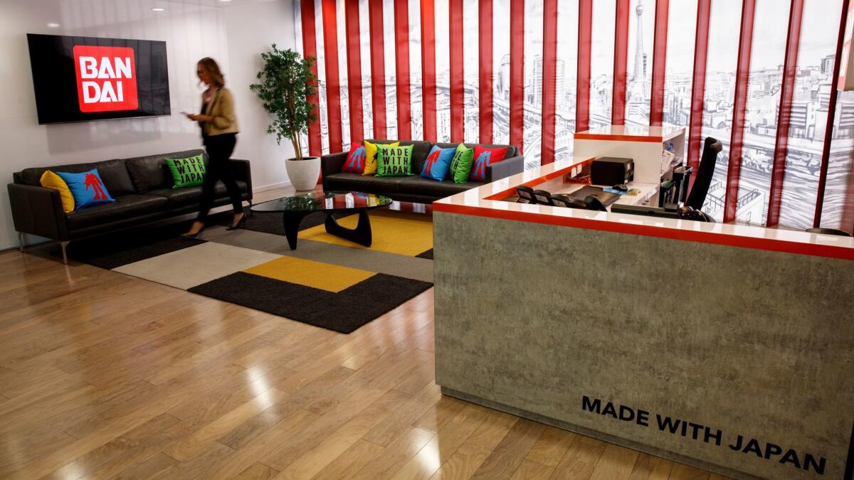 An employee walks through the lobby of Bandai America's headquarters in El Segundo.