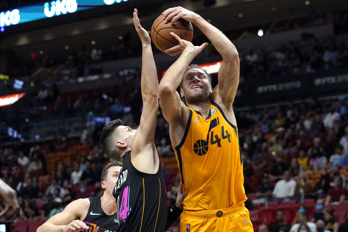 Utah Jazz forward Bojan Bogdanovic (44) is fouled by Miami Heat guard Tyler Herro (14) during the first half of an NBA basketball game, Saturday, Nov. 6, 2021, in Miami. (AP Photo/Lynne Sladky)