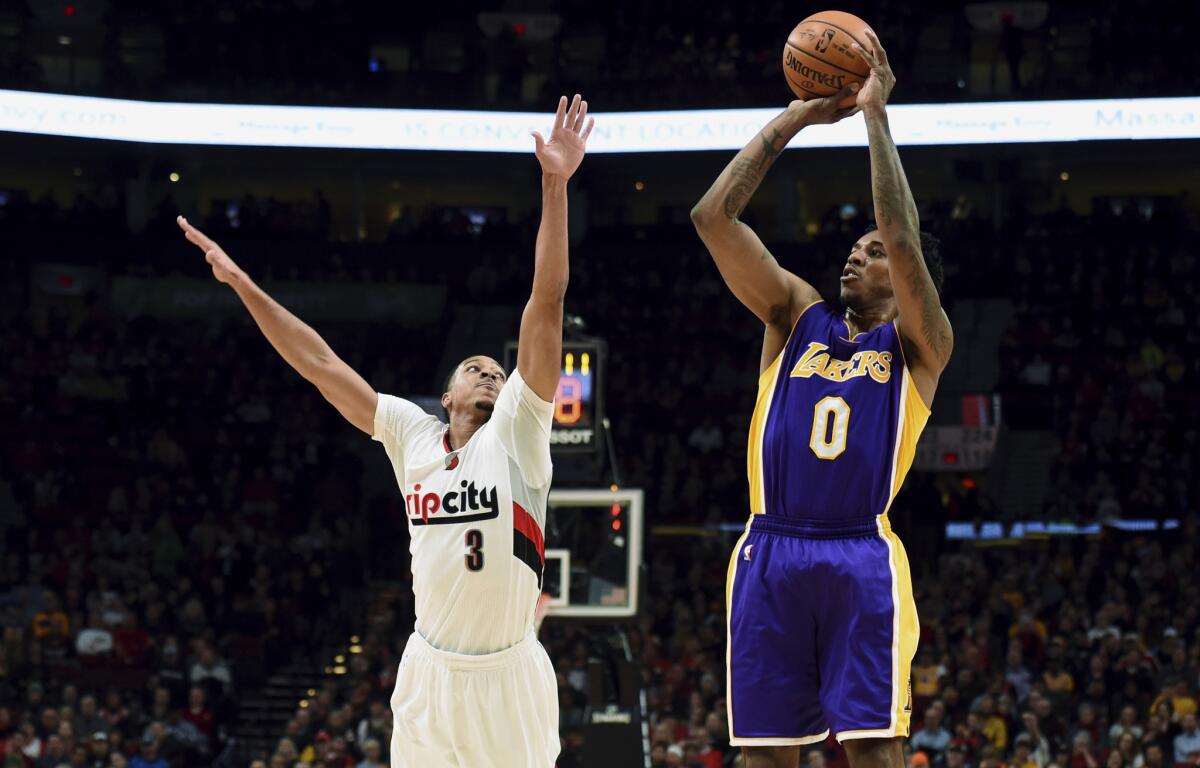 Lakers guard Nick Young hits a three-point shot over the Trail Blazers' C.J. McCollum on Jan. 25 in Portland.