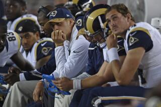 Jared Goff (16) sits on the bench in street clothes, hand on chin,  while the Rams played at the San Francisco 49ers in 2016.