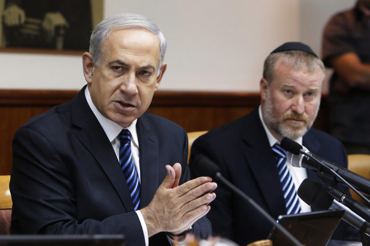 Israeli Prime Minister Benjamin Netanyahu, left, with Cabinet Secretary Avichai Mandelblit during a weekly meeting in Jerusalem on Sunday.