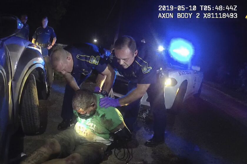 FILE - This file image from Louisiana State Police Trooper Dakota DeMoss' body-worn camera video shows other troopers holding up Ronald Greene before paramedics arrived on May 10, 2019, outside of Monroe, La. The video obtained by The Associated Press shows Louisiana state troopers stunning, punching and dragging the Black man as he apologizes for leading them on a high-speed chase. Greene died in police custody. (Louisiana State Police via AP, File)